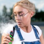 portrait-of-young-woman-vape-an-electronic-cigarette-outdoor-e1627032903216.jpeg
